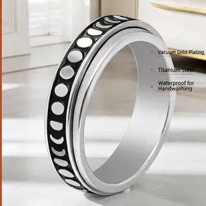 Rotating stainless steel moon star spinner ring with black geometric patterns