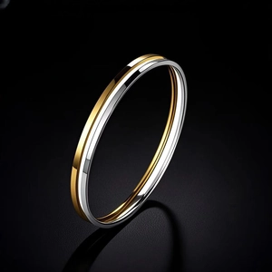 Macro shot of two-tone gold and silver stainless steel bangle with a polished mirror finish