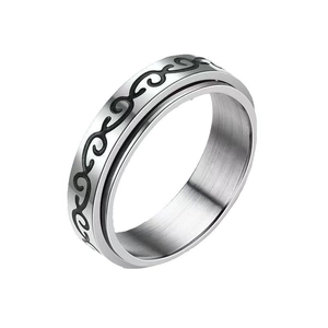 Minimalist stainless steel spinner ring with black engraved patterns on a silver band