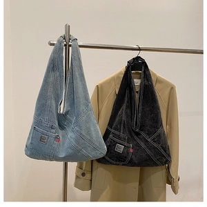 Détail de sacs cabas en denim délavé bleu clair et noir dans un cadre de mode décontracté