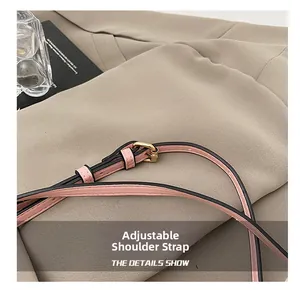 Detail of pink adjustable shoulder strap with gold metal buckle on a designer bag