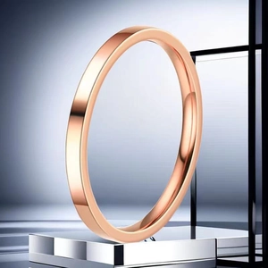 Detailed close-up of 10mm wide polished rose gold stainless steel ring on metal stand