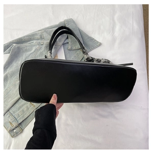 Detailed bottom view of large black PU leather tote bag with stylish plaid plush accent