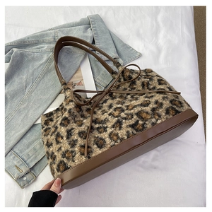 Leopard print plush tote bag with brown faux leather trim and ribbon detail decoration