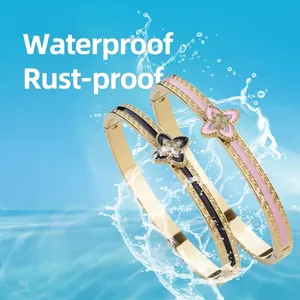 Gold-plated titanium steel clover bracelets with black and pink enamel in water splash scene