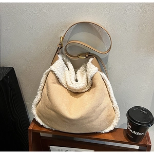 Gros plan du sac en daim kaki avec bordure en fausse fourrure blanche et sangle en cuir
