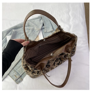 Detail view of large leopard print plush tote bag with inner lining and magnetic buckle
