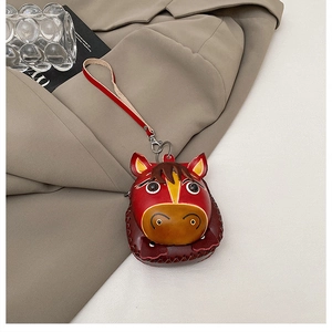 Macro shot of horse-shaped leather coin purse with stitching and metallic clasp