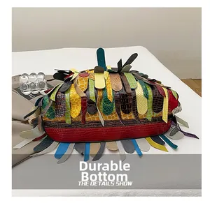 Detail of multi-color patchwork bag showing a wear-resistant bottom with leather texture