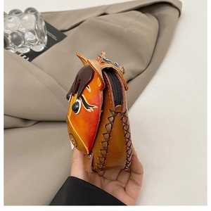 Macro shot of handmade 3D horse head leather coin purse with stitching detail
