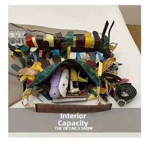 Macro view of large internal capacity of fringe hobo bag with assorted embossed textures