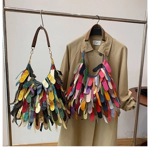 Detailed view of bohemian large hobo bag with colorful leather tassels and metal rings