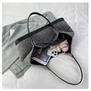 Detail of grey wool tweed tote bag showing large capacity for tablet and accessories