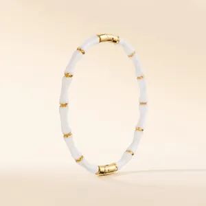 Bamboo-style gold plated stainless steel bangle with white enamel inlay segments