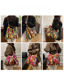 Detail of bohemian fringe shoulder bag with colorful layered leather strips and wide strap