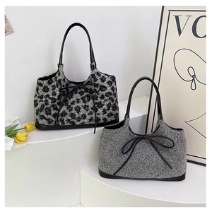 Detail of plush leopard print and grey knit handbags featuring leather bow decorations