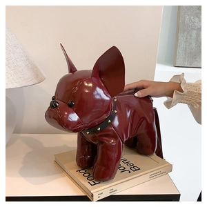 Close-up of wine red French Bulldog shaped crossbody bag with shiny leather texture