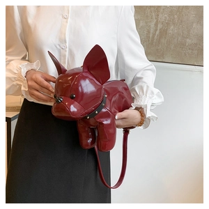 Detail of burgundy French Bulldog puppy crossbody bag with glossy patent leather finish