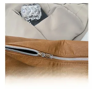 Close-up of smooth silver metal zipper on premium brown lychee pattern leather tote bag