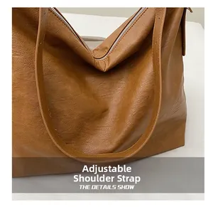 Detail shot of the adjustable shoulder strap on a brown soft leather business tote bag