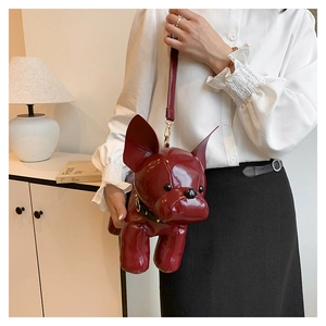 Close-up of a burgundy patent leather French Bulldog crossbody bag with rivet collar detail