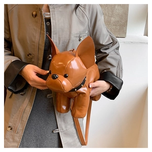 Detailed view of dog-shaped crossbody bag with studded collar and glossy brown finish