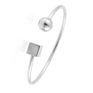 Detail of silver stainless steel cuff featuring a polished ball and a minimalist cube