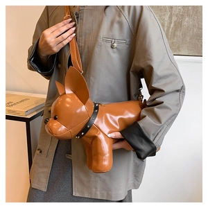 Detail view of brown leather French bulldog shaped crossbody bag with black rivet collar decoration