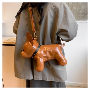 Detail of caramel faux leather bulldog crossbody bag with rivet collar and gold zipper