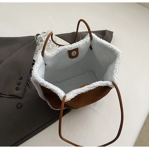 Close-up of the spacious interior with faux shearling lining and magnetic closure detail