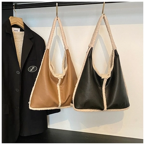 Detail of vintage tote bags in brown and black leather with fuzzy faux shearling trim