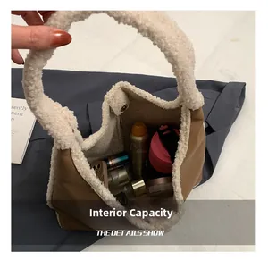 Spacious interior of faux leather and shearling tote bag holding daily essentials