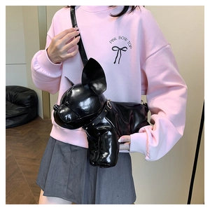 Detailed view of 3D French Bulldog shaped shoulder bag in black patent faux leather