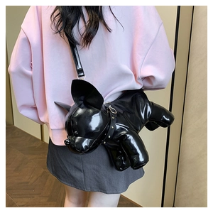 Detail of a black faux leather French Bulldog crossbody bag with gold studded collar
