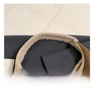 Close-up of pebble leather stitching and soft fleece trim on the comfortable tote handle