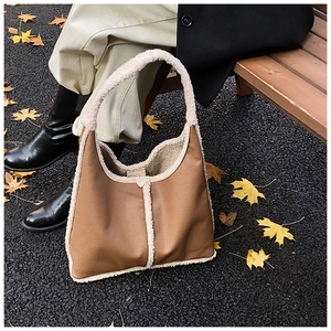 Detailed close-up of the vintage brown hobo bag featuring white faux shearling trim accents