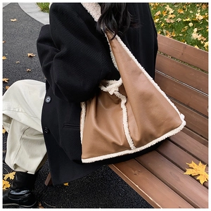 Detailed texture of brown pebbled leather bag with white plush wool trim for autumn