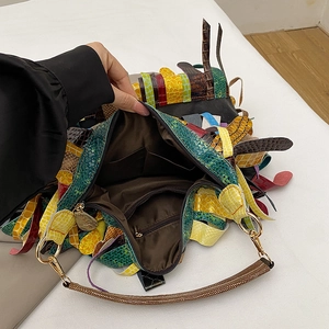 Bohemian patchwork leather tote bag with fringe details and spacious interior compartments