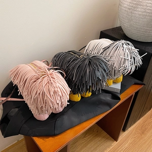 Quirky dog-shaped crossbody bags with long fringe texture in pink black and white