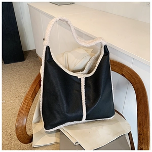 Detail of vintage tote bag featuring black leather and cream faux shearling patchwork