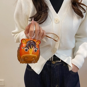 Cute horse-shaped mini leather coin purse with metallic keychain held by a hand