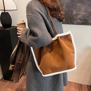 Brown fleece-lined tote bag with white faux fur trim for autumn winter fashion outfit