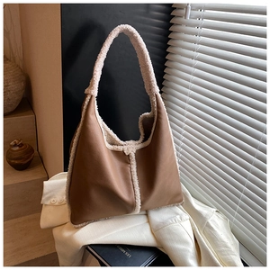 Detail of vintage brown leather tote bag featuring stylish white plush faux fur trim