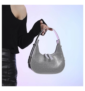 Detail of silver rhinestone hobo bag showing sparkling crystals and moon shape