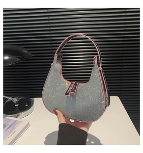 Macro detail of sparkly silver rhinestone crescent hobo bag with pink trim handle