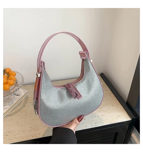 Detail of pink patent leather handle and silver metallic mesh hobo bag with zip closure