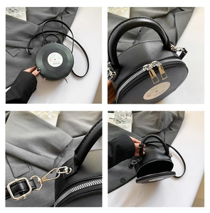 Detail view of black vinyl record bag with double zippers and metal feet accents