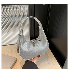 Close-up of sparkling silver rhinestone shoulder bag with metallic sequins and smooth zipper
