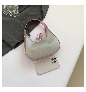 Detail view of mini silver rhinestone hobo bag with pink trim and dual zip closure