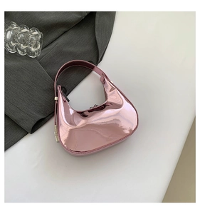 Close-up of metallic pink hobo bag with reflective mirror finish and silver hardware